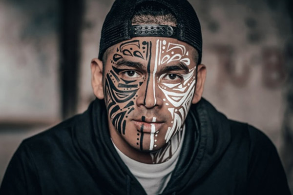 man with black and white face tattoo